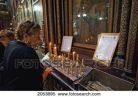 Stock Photography - Women Lighting Candles By The Virgin And Child Icon In The Church Of The Virgin Mary Or Hanging Church, Cairo, Al Qahirah, Egypt. Fotosearch