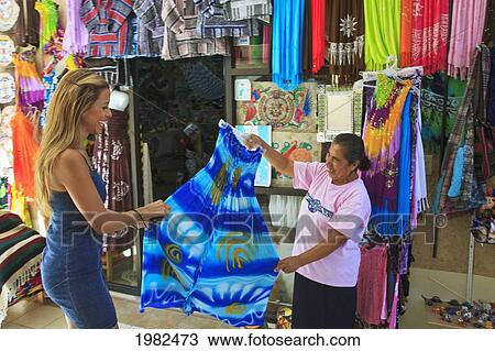 Women Looking At A Dress At A Downtown Shop; Todos Santos Baja California Sur Mexico View Large Photo Image Stock Image - Women Looking At A Dress At A Downtown Shop; Todos Santos Baja California Sur Mexico. Fotosearch