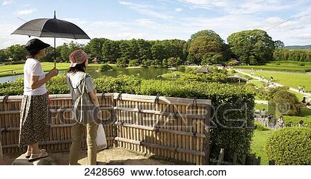 Women looking out over Koraku-En Gardens; Okayama, Okayama Prefecture, Japan View Large Photo Image Stock Photo - Women looking out over Koraku-En Gardens; Okayama, Okayama Prefecture, Japan. Fotosearch