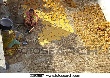 Stock Photo - Women making Chapatis on the roof of Castle Bijapur Rajasthan India. Fotosearch