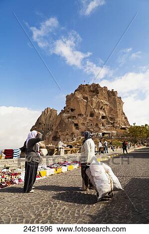 Women on the road with Uchisar Castle in the background; Uchisar, Cappadocia, Turkey View Large Photo Image Stock Photograph - Women on the road with Uchisar Castle in the background; Uchisar, Cappadocia, Turkey. Fotosearch