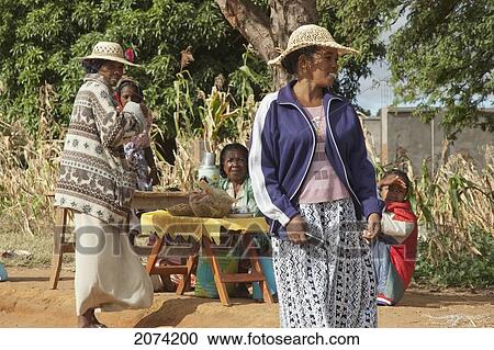 Stock Image - Women Selling Food Along The Road Between Ranohira & Ambalavao, Fianarantsoa Province, Madagascar. Fotosearch