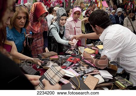 Stock Image - Women Shop For Ripoff And Fake Purses At Carsamba Pazari, The Wednesday Market In Fatih Is One Of Istanbul's Oldest And Most Colourful Market Places, Which Is Located Around A Network Of Streets Surrounding The Fatih Mosque In Istanbul, Turkey.. Fotosearch