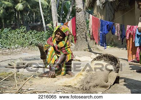 Stock Photography - Women Smashing Coconut Husks, Raghurajpur, Orissa, India. Fotosearch