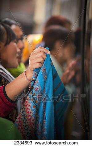 Stock Image - Women Trying On Colorful Saris; Darjeeling, West Bengal, India. Fotosearch