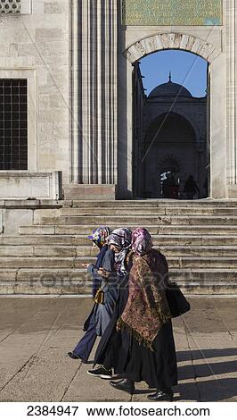 Women walking by the entrance to an Islamic Mosque; Istanbul, Turkey View Large Photo Image Stock Photo - Women walking by the entrance to an Islamic Mosque; Istanbul, Turkey. Fotosearch