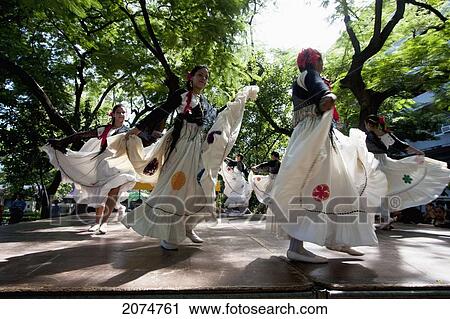 Stock Image - Women Wearing Traditional Dress Performing A Paraguayan Polka, Asuncion, Paraguay. Fotosearch