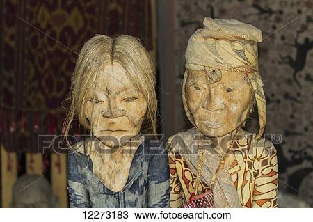 Stock Image - Wood-carved effigies of the deceased, called Tau tau, Lemo, Toraja Land, South Sulawesi, Indonesia. Fotosearch