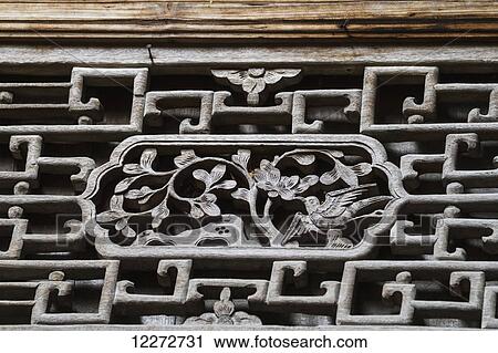 Stock Image - Wood carvings on a window of the Utopian Residence, Hongcun, Anhui, China. Fotosearch