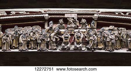Stock Image - Wooden beam decorated with carvings of scenes from Qing dynasty life in Chengzhi Hall, Hongcun, Anhui, China. Fotosearch