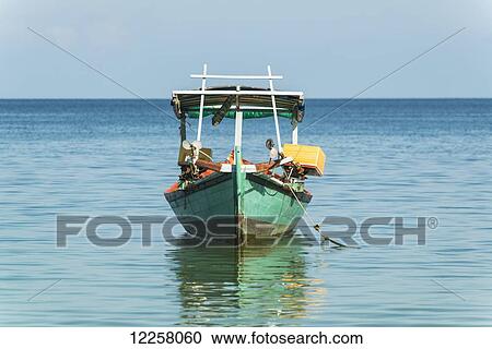 Stock Image - Wooden boat on the tranquil Gulf of Thailand; Sihanoukville, Cambodia. Fotosearch