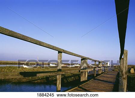 Wooden Bridge Over Water With Boats In Background View Large Photo Image Stock Photography - Wooden Bridge Over Water With Boats In Background. Fotosearch