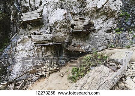 Stock Photo - Wooden coffins and skulls on a rocky outcrop, Kete Kesu, Toraja Land, South Sulawesi, Indonesia. Fotosearch