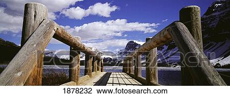 Stock Image - Wooden Jetty Over Bow Lake. Fotosearch