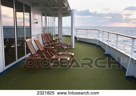 Wooden lounge chairs on deck of cruise ship at sunset; Tokyo, Japan View Large Photo Image Stock Photography - Wooden lounge chairs on deck of cruise ship at sunset; Tokyo, Japan. Fotosearch