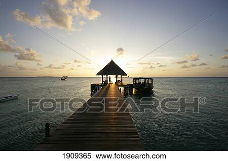 Wooden Pier In Ocean At Sunset, Dhuni Kolhu Island, Maldives View Large Photo Image Stock Photography - Wooden Pier In Ocean At Sunset, Dhuni Kolhu Island, Maldives. Fotosearch