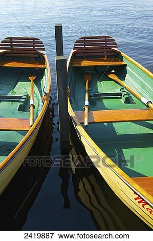 Wooden rowboats moored on a canal; Hamburg, Germany View Large Photo Image Stock Photo - Wooden rowboats moored on a canal; Hamburg, Germany. Fotosearch