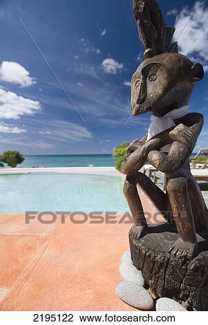 Stock Image - Wooden sculpture in front of the pool of La Luna Hotel, Portici, Grenada.. Fotosearch