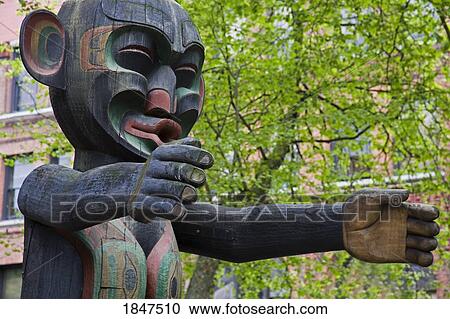 Stock Image - Wooden Statue In Pioneer Square; Seattle, Washington State, Usa. Fotosearch