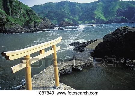 Stock Photo - Wooden Tori Gate At End Of Path In Ocean. Fotosearch