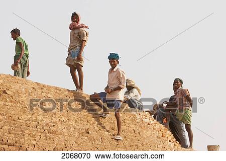 Stock Image - Workers On The Sujatagarh Stupa, Bodhgaya, Bihar, India. Fotosearch