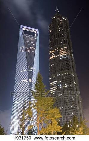 Stock Image - World Financial Building, Next To Jin Mao Building, At Night. Fotosearch