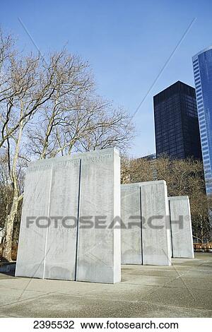Stock Image - World War Two monument in Battery Park with financial district in background; New York City, New York, United States of America. Fotosearch