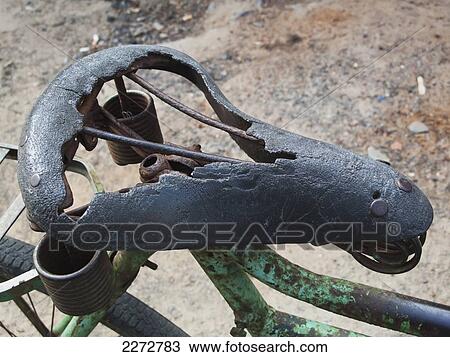 Stock Image - Worn-out bicycle seat; allepey kerala south india. Fotosearch