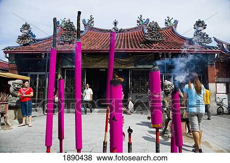 Stock Photo - Worshippers Lighting Joss Sticks And Offering Up Prayers. Fotosearch