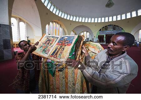 Worshippers looking at the ancient Bible in The Church of Our Lady Mary of Zion, the most important Church in Ethiopia; Axum, Tigray, Ethiopia View Large Photo Image Picture - Worshippers looking at the ancient Bible in The Church of Our Lady Mary of Zion, the most important Church in Ethiopia; Axum, Tigray, Ethiopia. Fotosearch