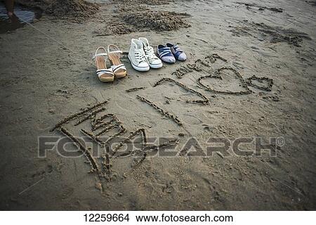 Picture - Xiamen's seaside, with shoes and writing in the sand; Xiamen, Fujian, China. Fotosearch