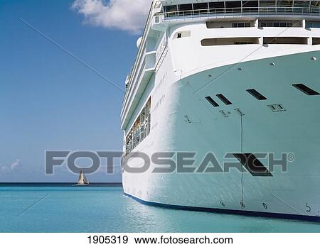Yacht Sailing Past The Norweigan Sky Cruise Ship In Bridgetown Port, Barbados. View Large Photo Image Stock Photo - Yacht Sailing Past The Norweigan Sky Cruise Ship In Bridgetown Port, Barbados.. Fotosearch