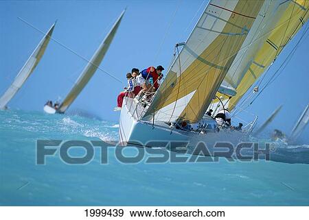 Stock Photo - Yachting Key West Race Week, Bow View Of Crew Tacking Sails Vertical To Ocean. Fotosearch