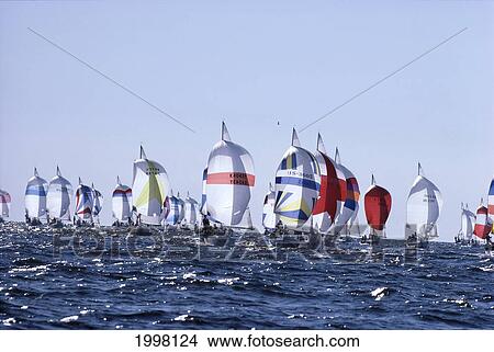 Yachting Race, Backlit Sails Many On Shimmery Ocean, Pale Blue Skies View Large Photo Image Picture - Yachting Race, Backlit Sails Many On Shimmery Ocean, Pale Blue Skies. Fotosearch