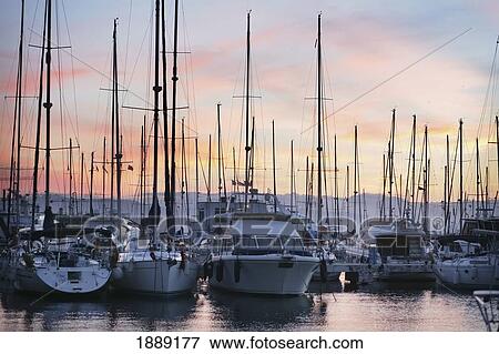 Stock Photo - Yachts And Boats In Marina Bay At Sunset. Fotosearch