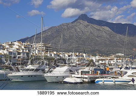 Stock Photography - Yachts In Harbour By Mountain. Fotosearch