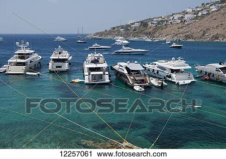Stock Image - Yachts moored off Ornos Beach; Mykonos, Cyclades, Greek Islands, Greece. Fotosearch