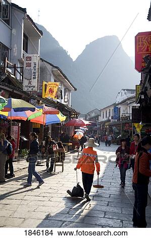 Picture - Yangshuo, China; Pedestrians Walking Through Town. Fotosearch