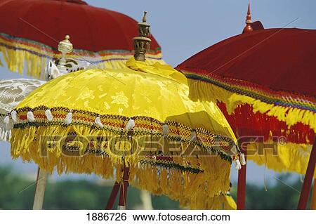 Stock Photograph - Yellow And Red Parasols On The Beach For Balinese New Year. Fotosearch