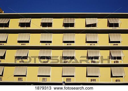 Stock Image - Yellow Apartment Building, Close Up. Fotosearch