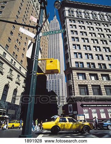 Yellow Cabs On Broadway With Empire State Building In Back View Large Photo Image Stock Photo - Yellow Cabs On Broadway With Empire State Building In Back. Fotosearch
