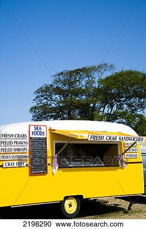 Stock Image - Yellow Caravan That Sells Seafood/ Crab Sandwiches., Blakeney, Norfolk, Uk.. Fotosearch
