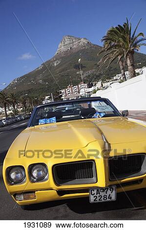 Stock Photo - Yellow Sports Car Parked In Camp's Bay, Cape Town; Bright, Cool Cars Parked In Camp's Bay, Cape Town, South Africa&#13; &#10. Fotosearch