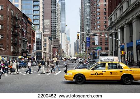 Stock Image - Yellow Taxi And Pedestrians Crossing The 6Th Avenue, Manhattan, New York, Usa. Fotosearch