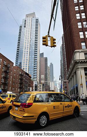 Stock Image - Yellow taxis in the 6th Avenue, Manhattan, New York, USA. Fotosearch