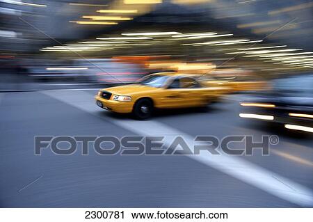 Stock Image - Yellow Taxis, Park Avenue, Midtown Manhattan; New York City, New York, United States of America. Fotosearch