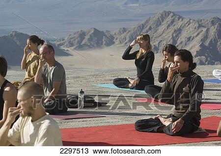 Stock Image - Yoga 'salutation to the sun' performed in front of the Shanti (Peace) Stupa overlooking Leh. Ladakh, Province of Jammu and Kashmir, India. Fotosearch
