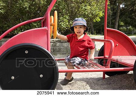 Young Asian-Caucasian Boy Driving A Toy Truck; Ontario Canada View Large Photo Image Stock Image - Young Asian-Caucasian Boy Driving A Toy Truck; Ontario Canada. Fotosearch