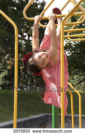 Young Asian-Caucasian Girl Hanging Upside Down On Playground Equipment; Ontario Canada View Large Photo Image Stock Image - Young Asian-Caucasian Girl Hanging Upside Down On Playground Equipment; Ontario Canada. Fotosearch