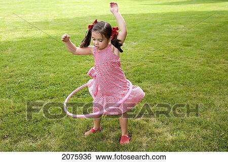 Young Asian-Caucasian Girl Playing With Her Hula Hoop; Ontario Canada View Large Photo Image Stock Photograph - Young Asian-Caucasian Girl Playing With Her Hula Hoop; Ontario Canada. Fotosearch